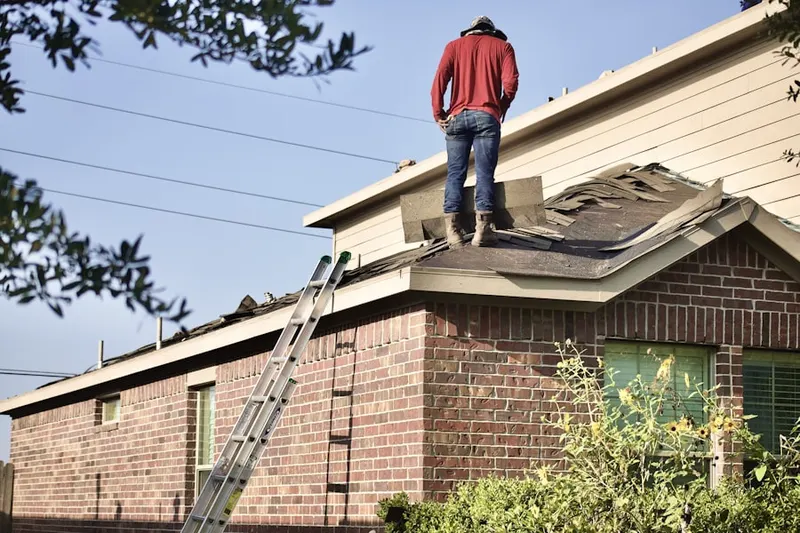Professional roofer working on a residential roof in Leases Corner